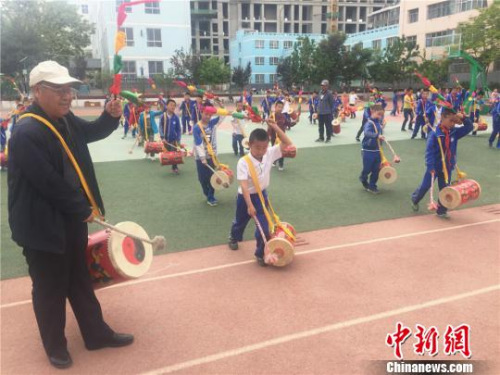 魏永宏一板一眼地指導孩子們打鼓的每個動作?！∈缝o靜 攝