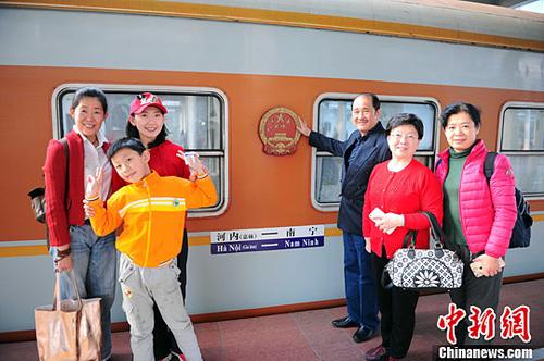 資料圖為中國出境游客在掛有中國國徽的車廂前合影留念。<a target='_blank' >中新社</a>記者 蔣雪林 攝