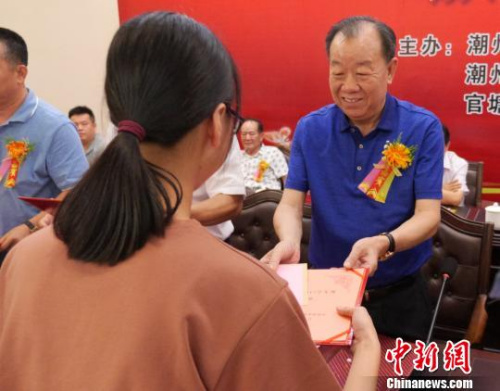 謝賢團向獲獎學子頒發(fā)獎學金?！￡悊⑷?攝