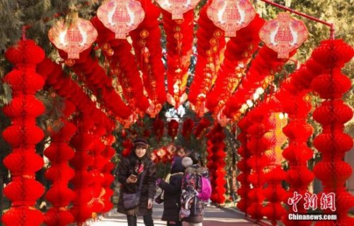 資料圖：2018年2月2日，北京地壇公園，市民經(jīng)過掛滿紅燈籠的通道。隨著農(nóng)歷春節(jié)的臨近，北京城年味漸濃。<a target='_blank' >中新社</a>記者 侯宇 攝