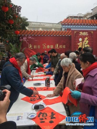 廈門思明區(qū)僑聯(lián)給歸僑僑眷寫春聯(lián)送祝福?！×謺熈?攝