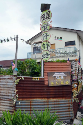 隨風(fēng)擺動(dòng)的“祖屋凳仔鮮蛤”垂直招牌特別顯見(jiàn)。(馬來(lái)西亞《中國(guó)報(bào)》記者 趙詩(shī)綺 攝)
