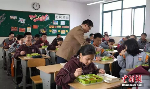 南京鐘英中學(xué)的校長走進(jìn)教室與學(xué)生一起吃中飯。葛勇 攝