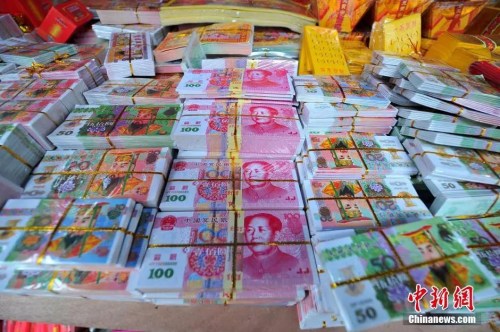 資料圖：祭祀用品市場現(xiàn)許多高仿真十元到百元、百萬乃至百億面額的冥幣大鈔票。胡雁 攝