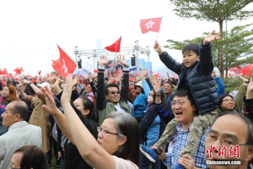 12月15日，香港小朋友高舉香港特區(qū)區(qū)旗參加集會。當(dāng)日，大批香港市民自發(fā)在香港添馬公園發(fā)起控訴暴力集會，希望通過此次集會表達摒棄暴力、堅守法治的心聲，強烈譴責(zé)示威者的暴力行為，并支持警察嚴(yán)正執(zhí)法。<a target='_blank' >中新社</a>記者 謝光磊 攝
