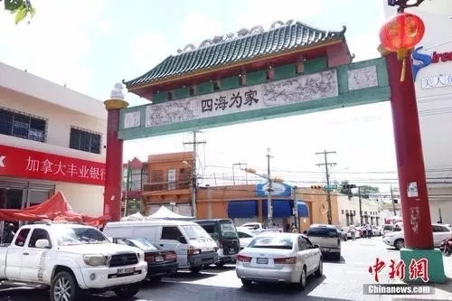 2019年3月24日，在多米尼加首都圣多明各，“唐人街”出口處一座牌坊上刻著“四海為家”四個(gè)大字。這里分布著數(shù)百家華人店鋪、商場和中餐館，是旅居多米尼加華僑華人的主要聚集地。<a target='_blank' >中新社</a>記者莫成雄 攝