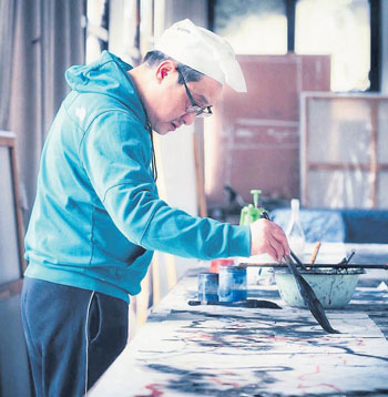 　蔣山青在創(chuàng)作畫作。
