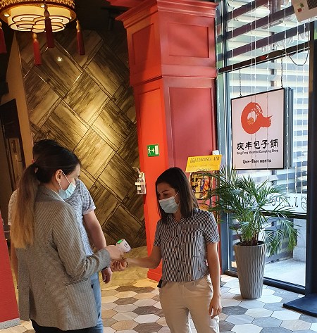 “九澤烤鴨”專(zhuān)設(shè)服務(wù)員給進(jìn)店顧客測(cè)量體溫。(“哈薩克斯坦新觀(guān)察”微信公眾號(hào))