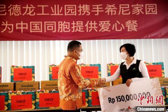 圖為徐捷向希尼家園負(fù)責(zé)人佟桐女士提供愛(ài)心支票。　印尼德龍工業(yè)園 供圖
