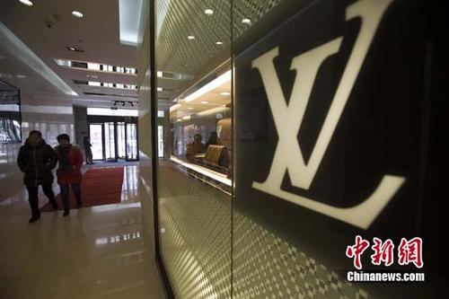 中國僑網(wǎng)資料圖:民眾從某知名奢侈品店經(jīng)過。中新社記者 張云 攝