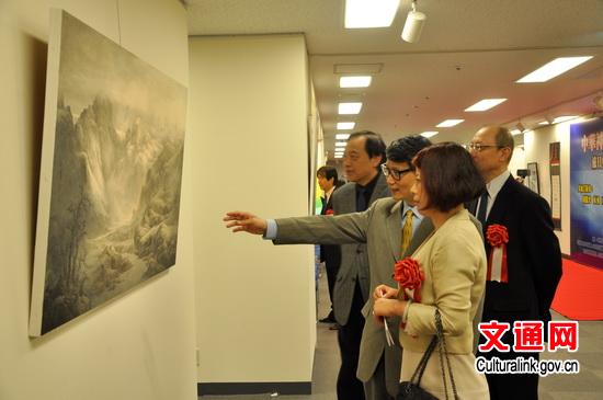 中國僑網(wǎng)藝術家向劉亞明總領事(近一)介紹作品。